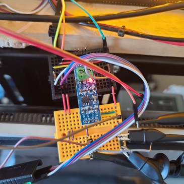 An RS485 transceiver connected to the device under test, a host PC, and two oscilloscope probes.