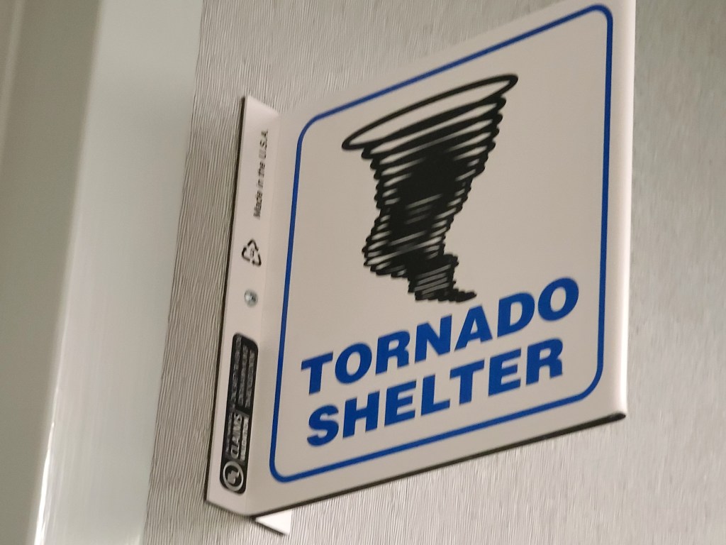 Tornado Shelter sign in office.